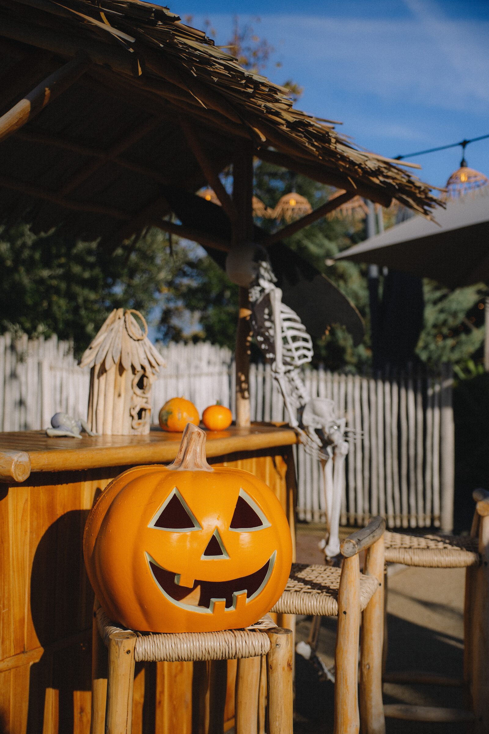 A carved pumpkin in front of the campsite bar decorated for Halloween