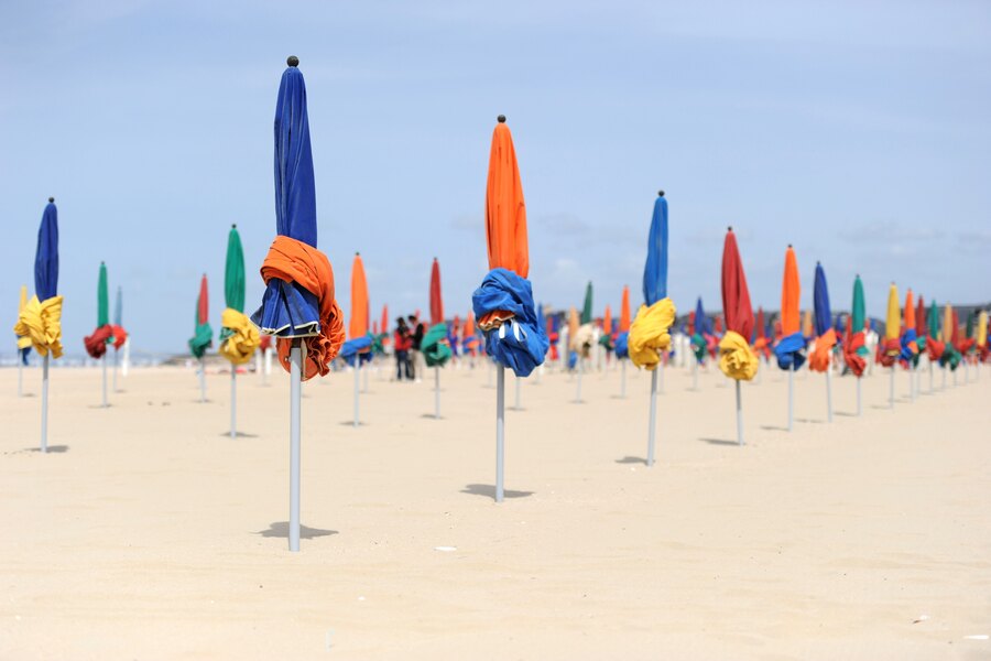 Multicoloured parasols lined up on the beach at Deauville